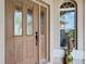 Detailed view of the wood front door with etched glass panels at 2673 Beckett Run, The Villages, FL 32162