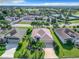 Aerial view of a single-Gathering house with a three-car garage and palm trees at 2673 Beckett Run, The Villages, FL 32162