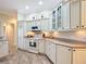 White kitchen with ample cabinetry and granite countertops at 2673 Beckett Run, The Villages, FL 32162