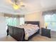 Bright main bedroom with a king-size bed and access to the patio at 2673 Beckett Run, The Villages, FL 32162