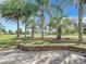 Landscaped patio with brick wall and lush tropical plants at 2673 Beckett Run, The Villages, FL 32162