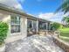 Stone patio adjacent to a house with screened-in porch at 2673 Beckett Run, The Villages, FL 32162