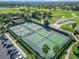 Aerial view of community tennis courts with multiple players at 2673 Beckett Run, The Villages, FL 32162