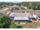 Property's roof, screened patio, and backyard shown from above at 326 N Sunset Dr, Mount Dora, FL 32757