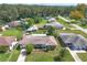 An aerial view showing the house, backyard, and surrounding neighborhood at 326 N Sunset Dr, Mount Dora, FL 32757