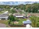 Aerial view of house, showcasing backyard with patio and firepit at 326 N Sunset Dr, Mount Dora, FL 32757