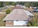 Aerial view showcasing home's roof, backyard, and screened patio at 326 N Sunset Dr, Mount Dora, FL 32757