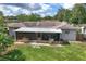 Aerial view of house, showcasing backyard with screened patio at 326 N Sunset Dr, Mount Dora, FL 32757