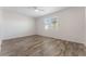 Bright bedroom featuring wood-look floors and ceiling fan at 555 Meadow Pointe Dr, Haines City, FL 33844