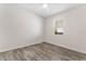 Bedroom with wood-look flooring and a window with blinds at 555 Meadow Pointe Dr, Haines City, FL 33844