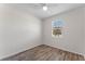 Simple bedroom with wood-look flooring and a window with blinds at 555 Meadow Pointe Dr, Haines City, FL 33844