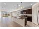 Modern kitchen featuring dark cabinetry, granite countertops, and stainless steel appliances at 555 Meadow Pointe Dr, Haines City, FL 33844