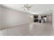 Open floor plan living room with tile flooring, and views into the kitchen area at 555 Meadow Pointe Dr, Haines City, FL 33844