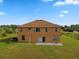 Aerial view of the tan house showing the large backyard, patio, and mature landscaping at 18744 Sabal St, Orlando, FL 32833