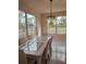 Light-filled dining area with large windows and a stylish chandelier above a glass table at 18744 Sabal St, Orlando, FL 32833