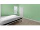 Cozy bedroom with light green walls and a comfortable bed at 25304 Forest Oak Ct, Leesburg, FL 34748