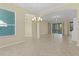 Spacious dining room with tile floors and chandelier at 25304 Forest Oak Ct, Leesburg, FL 34748