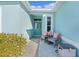 Inviting entryway with teal exterior and sitting area at 25304 Forest Oak Ct, Leesburg, FL 34748