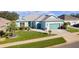 Single-story home with teal exterior and attached garage at 25304 Forest Oak Ct, Leesburg, FL 34748