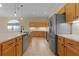 Well-lit kitchen with stainless steel appliances, oak cabinets, and white countertops at 25304 Forest Oak Ct, Leesburg, FL 34748