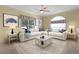 Cozy living room with large sectional sofa, accent pillows, and coastal-themed decor at 25304 Forest Oak Ct, Leesburg, FL 34748