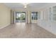 Bright living room with built-in shelving and access to a screened patio at 25304 Forest Oak Ct, Leesburg, FL 34748
