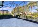 Relaxing screened patio with paver stones and backyard view at 25304 Forest Oak Ct, Leesburg, FL 34748