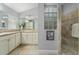 Bathroom features double vanities and a glass block shower enclosure at 768 Bradford Loop, The Villages, FL 32163