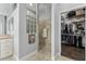 Bathroom with walk-in shower, glass block feature, and large closet at 768 Bradford Loop, The Villages, FL 32163