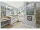 Double vanity bathroom with a large walk-in shower at 768 Bradford Loop, The Villages, FL 32163