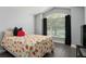Bedroom with large window, and floral bedding at 768 Bradford Loop, The Villages, FL 32163