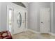 Bright entryway with decorative door and tiled floor at 768 Bradford Loop, The Villages, FL 32163