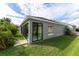 Gray house with three car garage, landscaping and driveway at 768 Bradford Loop, The Villages, FL 32163