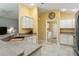 Kitchen with access to laundry and features white cabinets at 768 Bradford Loop, The Villages, FL 32163