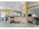 Eat-in kitchen with breakfast bar and view into the living room at 768 Bradford Loop, The Villages, FL 32163