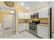Bright kitchen features stainless steel appliances and ample cabinetry at 768 Bradford Loop, The Villages, FL 32163