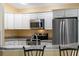 Clean kitchen, stainless steel appliances, and white cabinets at 768 Bradford Loop, The Villages, FL 32163