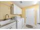 Laundry room with washer, dryer, and utility sink at 768 Bradford Loop, The Villages, FL 32163