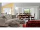 Living room with comfy seating and view of dining area at 768 Bradford Loop, The Villages, FL 32163