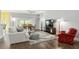 Living area with hardwood floors, sofa, and armchairs at 768 Bradford Loop, The Villages, FL 32163