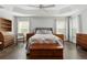 Main bedroom with hardwood floors, large windows, and ceiling fan at 768 Bradford Loop, The Villages, FL 32163