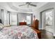 Main bedroom with ensuite bathroom access and ceiling fan at 768 Bradford Loop, The Villages, FL 32163