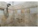 Walk-in shower with double shower heads and neutral tile at 768 Bradford Loop, The Villages, FL 32163