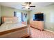 Bedroom with wood bed frame and dresser, plus a ceiling fan at 1072 Se 155Th St, Summerfield, FL 34491