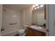 Bathroom features a shower-tub combo, wood-look floors, and vanity at 17755 Se 85Th Ellerbe Ave, The Villages, FL 32162