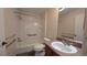 Clean bathroom with tiled shower, wood-look floors, and grab bars for accessibility at 17755 Se 85Th Ellerbe Ave, The Villages, FL 32162