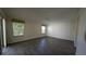 Spacious bedroom featuring wood-look floors, a ceiling fan and two windows at 17755 Se 85Th Ellerbe Ave, The Villages, FL 32162