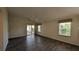 Spacious bedroom features wood-look floors, ceiling fan and sliding glass door to sunroom at 17755 Se 85Th Ellerbe Ave, The Villages, FL 32162