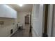 Functional laundry area featuring a sink, storage cabinets, and access to the garage at 17755 Se 85Th Ellerbe Ave, The Villages, FL 32162