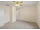 Well-lit bedroom featuring ceiling fan and door at 32857 Timberwood Dr, Leesburg, FL 34748